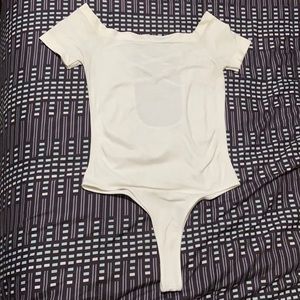 Woman’s white stretchy onesie